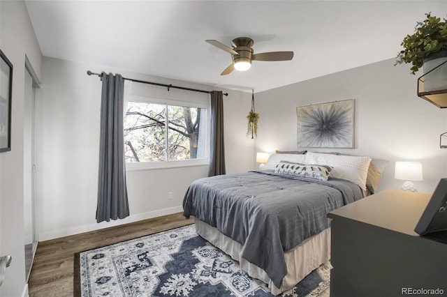 bedroom featuring ceiling fan, baseboards, and wood finished floors