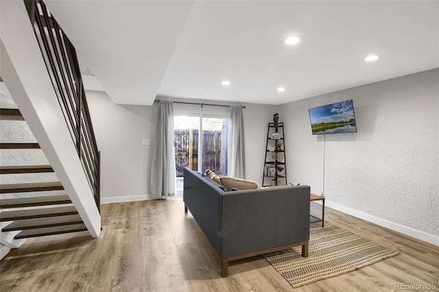 living area featuring recessed lighting, stairway, baseboards, and wood finished floors