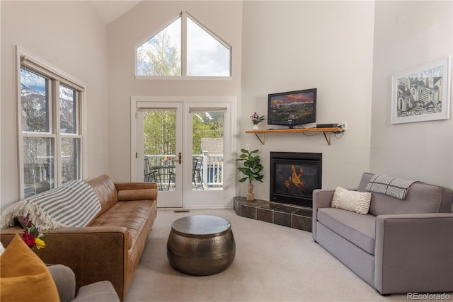 218 Highland Ter, Breckenridge, CO 80424 - living room featuring carpet floors, a high ceiling, a fireplace, and healthy amount of natural light