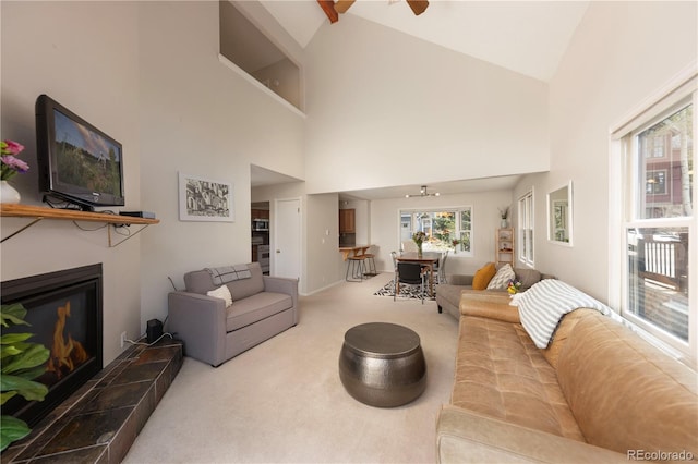 218 Highland Ter, Breckenridge, CO 80424 - carpeted living area with a ceiling fan, a tile fireplace, and high vaulted ceiling