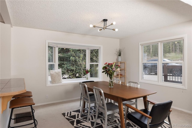 218 Highland Ter, Breckenridge, CO 80424 - dining area with a textured ceiling, a chandelier, and light carpet