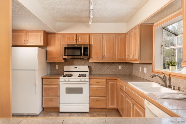 218 Highland Ter, Breckenridge, CO 80424 - kitchen with white appliances, a textured ceiling, backsplash, and light tile patterned floors