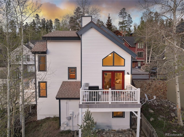 218 Highland Ter, Breckenridge, CO 80424 - back of house with a chimney, a shingled roof, and a deck
