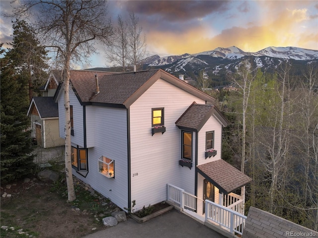 218 Highland Ter, Breckenridge, CO 80424 - property exterior at dusk featuring a mountain view and roof with shingles