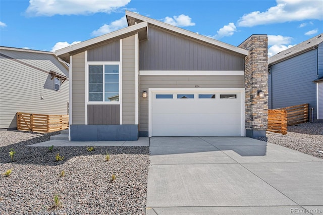 9314 Biscay St, Commerce City, CO 80022 - view of front of home with driveway, an attached garage, and fence
