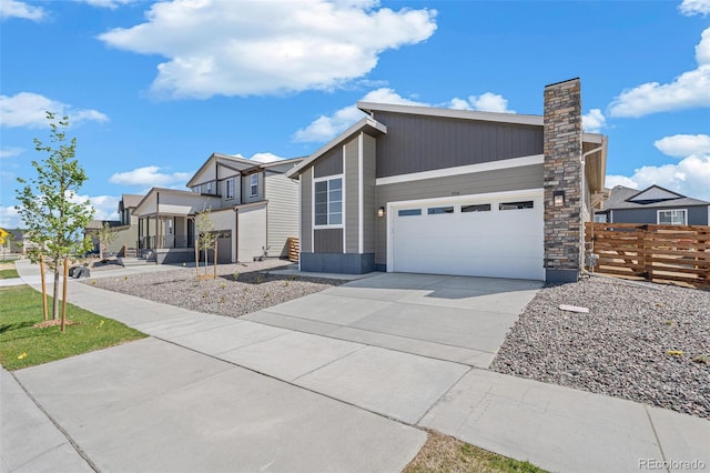 9314 Biscay St, Commerce City, CO 80022 - view of front facade with fence, a garage, a chimney, and driveway