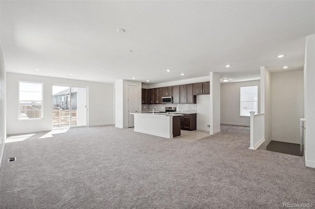 9314 Biscay St, Commerce City, CO 80022 - kitchen featuring plenty of natural light, open floor plan, appliances with stainless steel finishes, and dark brown cabinetry