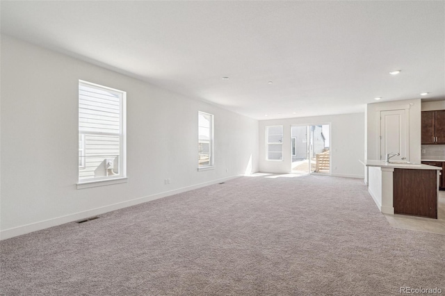 9314 Biscay St, Commerce City, CO 80022 - unfurnished living room featuring baseboards, recessed lighting, and visible vents