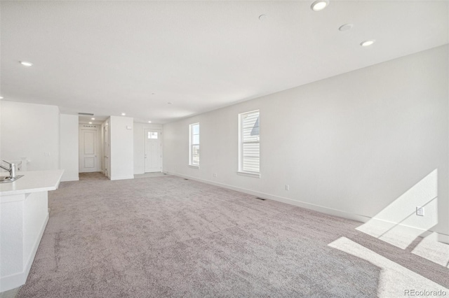 9314 Biscay St, Commerce City, CO 80022 - unfurnished room with baseboards, light carpet, and recessed lighting