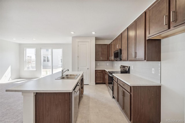9314 Biscay St, Commerce City, CO 80022 - kitchen featuring light countertops, appliances with stainless steel finishes, an island with sink, and a sink
