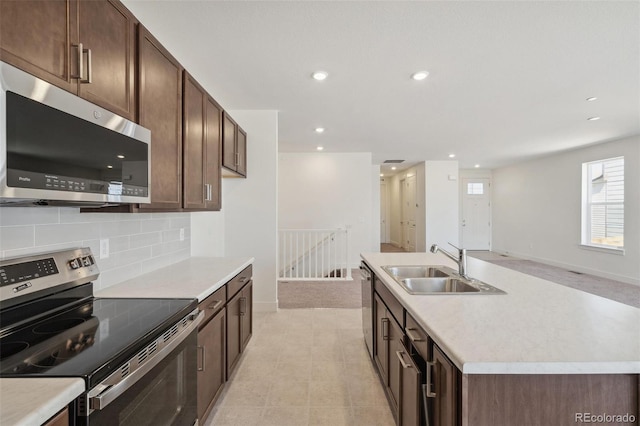 9314 Biscay St, Commerce City, CO 80022 - kitchen with a sink, tasteful backsplash, light countertops, and appliances with stainless steel finishes