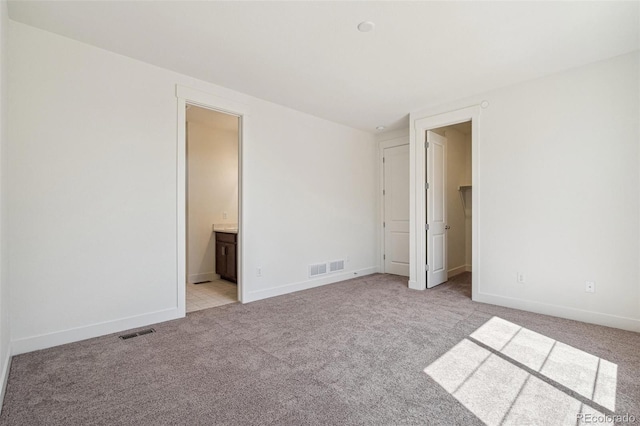 9314 Biscay St, Commerce City, CO 80022 - unfurnished bedroom featuring baseboards, light carpet, visible vents, and a walk in closet