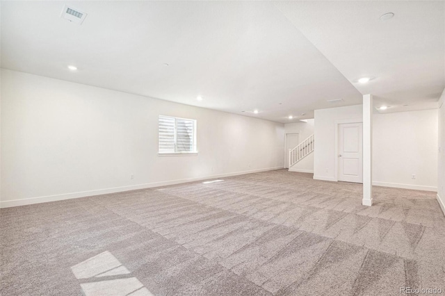 9314 Biscay St, Commerce City, CO 80022 - basement featuring stairway, baseboards, visible vents, light colored carpet, and recessed lighting