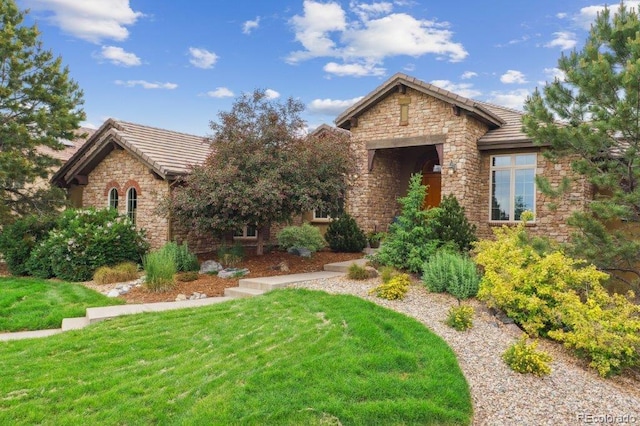 4651 Sonado Pl, Parker, CO 80134 - view of front of property with stone siding, a tiled roof, and a front yard