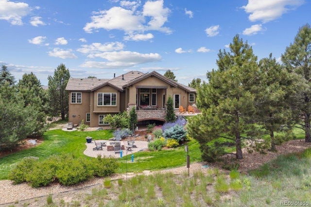 4651 Sonado Pl, Parker, CO 80134 - back of house featuring an outdoor fire pit, stucco siding, a patio, and a lawn
