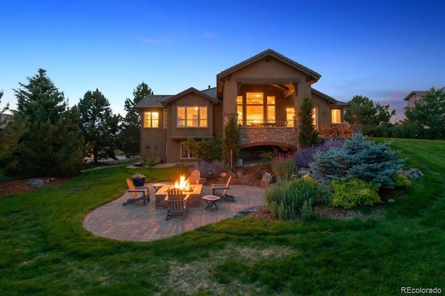 4651 Sonado Pl, Parker, CO 80134 - back of house with a fire pit, a patio, a lawn, and stucco siding