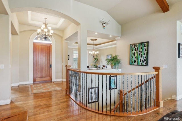 4651 Sonado Pl, Parker, CO 80134 - foyer featuring a chandelier, a raised ceiling, arched walkways, and crown molding
