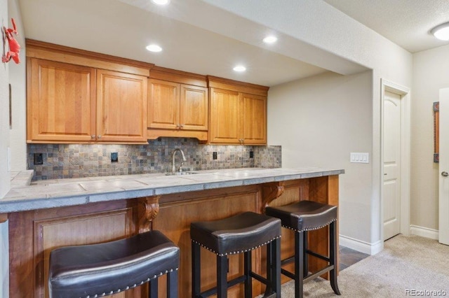 4651 Sonado Pl, Parker, CO 80134 - kitchen with a kitchen bar, tasteful backsplash, carpet floors, recessed lighting, and tile countertops