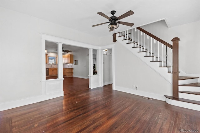 unfurnished living room with ceiling fan and dark hardwood / wood-style flooring