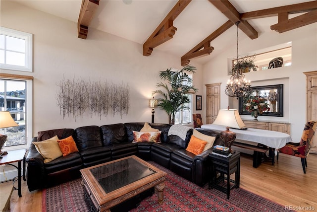 living room with beamed ceiling, high vaulted ceiling, an inviting chandelier, and light hardwood / wood-style floors