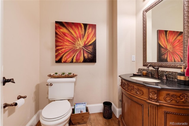 bathroom featuring vanity, hardwood / wood-style floors, and toilet