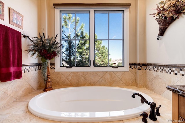 bathroom with tiled bath and a wealth of natural light