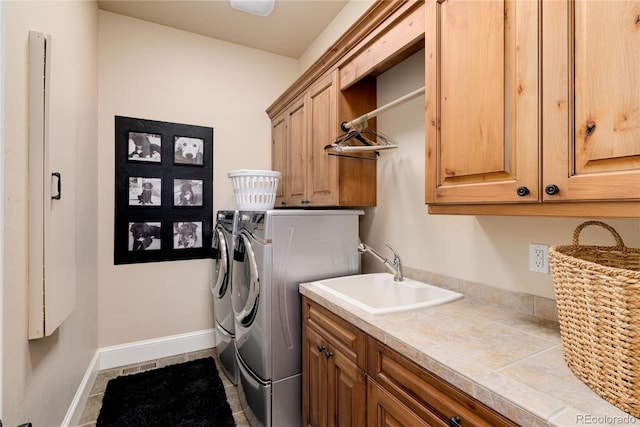 washroom featuring cabinets, tile patterned flooring, sink, and washer and dryer