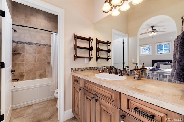 full bathroom featuring vanity, ceiling fan with notable chandelier, shower / bath combo, and toilet