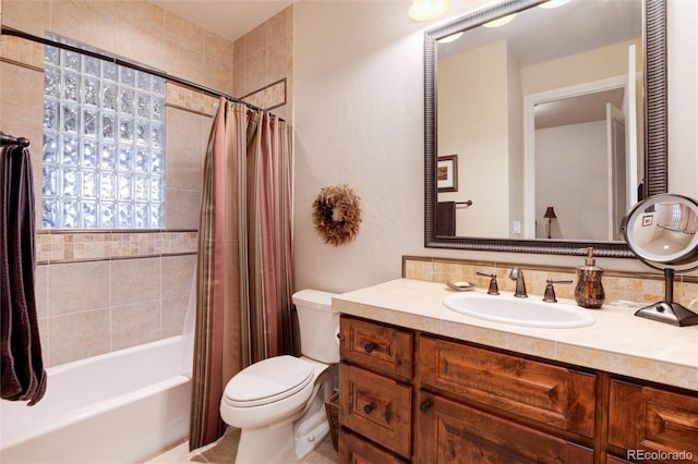 full bathroom with vanity, shower / tub combo with curtain, and toilet