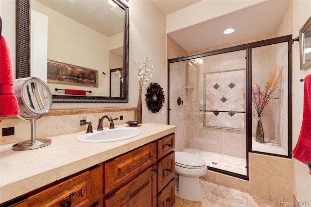 bathroom with decorative backsplash, vanity, an enclosed shower, and toilet