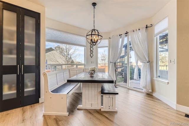 7378 Geode Ct, Castle Rock, CO 80108 - unfurnished dining area featuring a chandelier, baseboards, and wood finished floors
