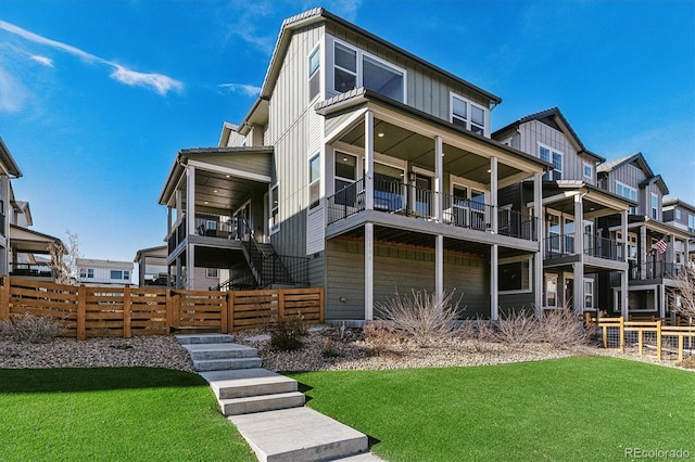 rear view of property with a lawn