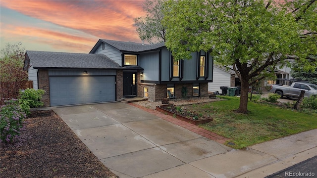 tri-level home with brick siding, a garage, concrete driveway, a front yard, and roof with shingles