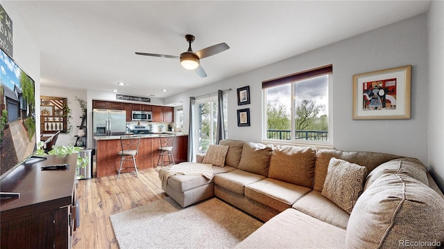 10759 Clermont St, Thornton, CO 80233 - living room featuring light wood finished floors, a ceiling fan, and recessed lighting