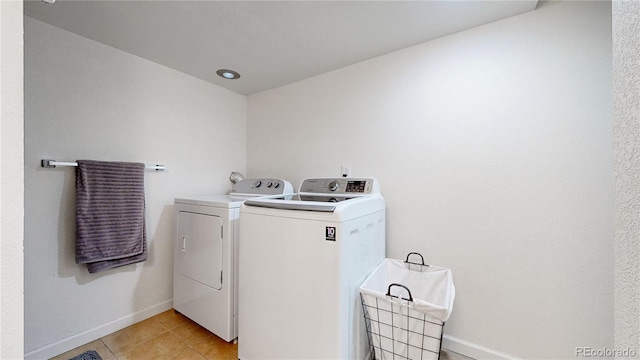 10759 Clermont St, Thornton, CO 80233 - washroom with separate washer and dryer and light tile patterned flooring