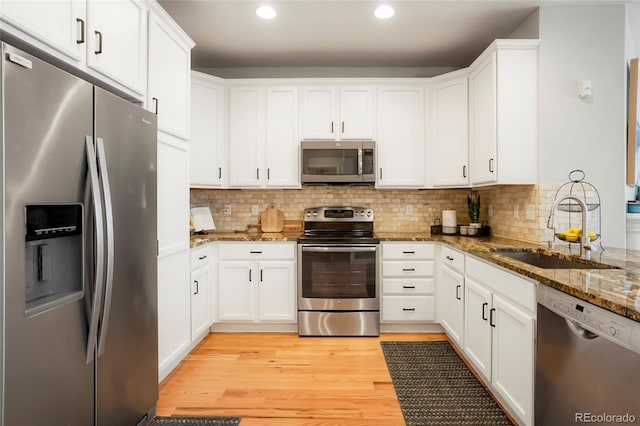8427 E 35th Ave, Denver, CO 80238 - kitchen featuring stainless steel appliances, a sink, recessed lighting, white cabinets, and stone counters