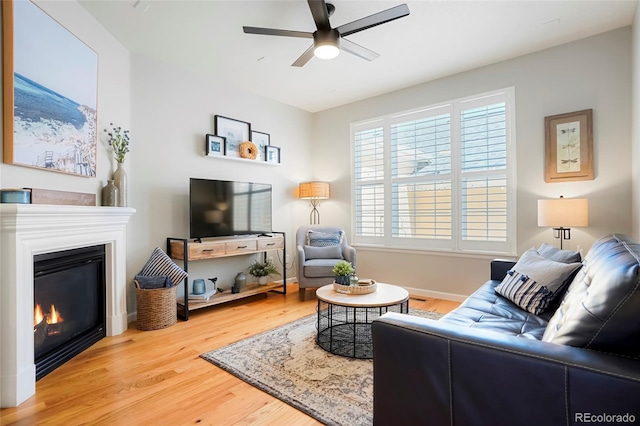 8427 E 35th Ave, Denver, CO 80238 - living area featuring ceiling fan, wood finished floors, a glass covered fireplace, and baseboards