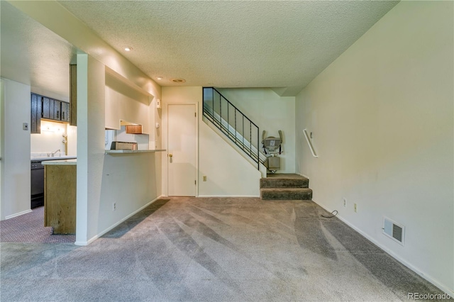3351 S Field St Unit 191, Lakewood, CO 80227 - unfurnished living room with carpet floors, a textured ceiling, stairway, recessed lighting, and baseboards