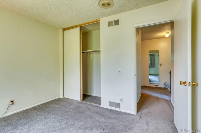 3351 S Field St Unit 191, Lakewood, CO 80227 - unfurnished bedroom featuring a textured ceiling, carpet flooring, a closet, and baseboards