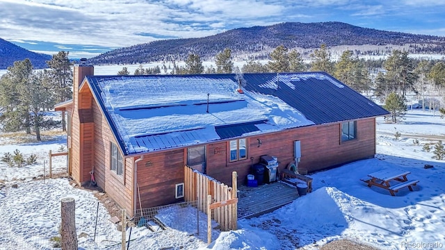 view of snowy exterior with a mountain view