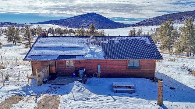 view of snowy exterior with a mountain view