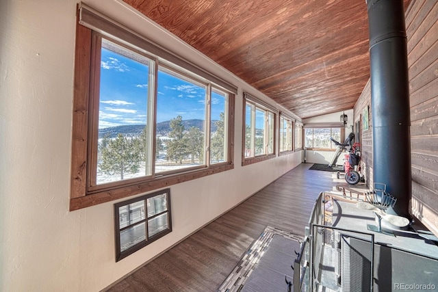 unfurnished sunroom with vaulted ceiling, wood ceiling, and a mountain view