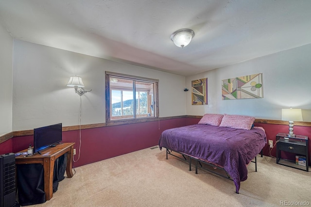 bedroom featuring light carpet