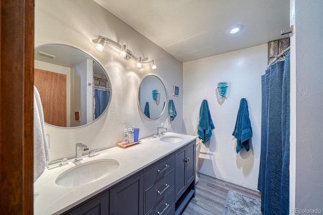 bathroom with vanity and hardwood / wood-style flooring