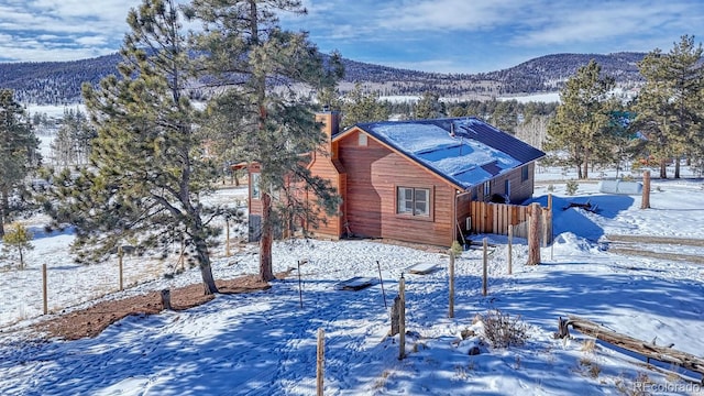 view of snow covered exterior with a mountain view