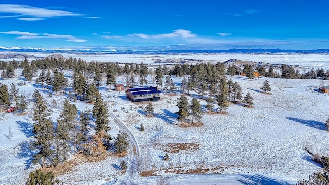 snowy aerial view with a mountain view