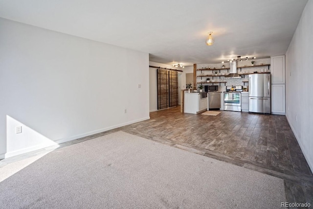 1625 Larimer St Unit 3004, Denver, CO 80202 - unfurnished living room with a barn door and baseboards