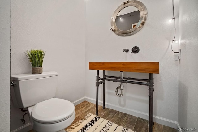 1625 Larimer St Unit 3004, Denver, CO 80202 - half bathroom with wood finished floors, toilet, and baseboards