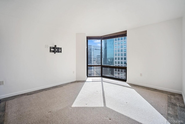 1625 Larimer St Unit 3004, Denver, CO 80202 - empty room featuring a wall of windows and baseboards