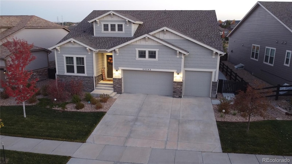 craftsman-style house featuring a garage and a front yard